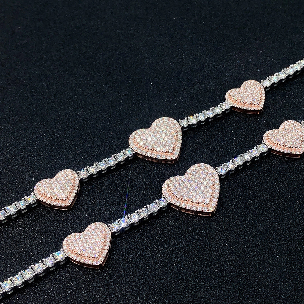 Close up view showing round moissanite strand and pave rose gold heart charm links