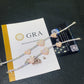 Two pave heart moissanite tennis bracelets displayed with official GRA report card