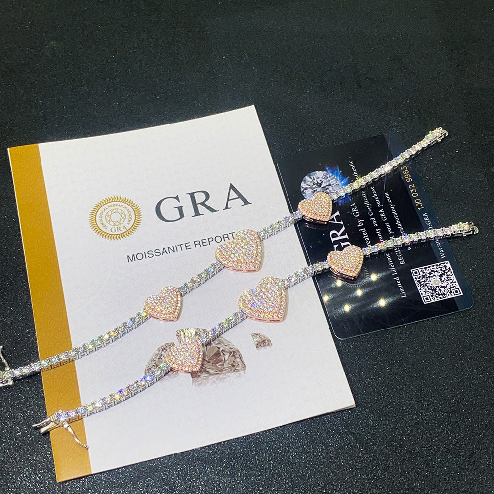 Two pave heart moissanite tennis bracelets displayed with official GRA report card