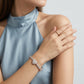 Model wearing pave heart moissanite tennis bracelet with rose gold accents on wrist