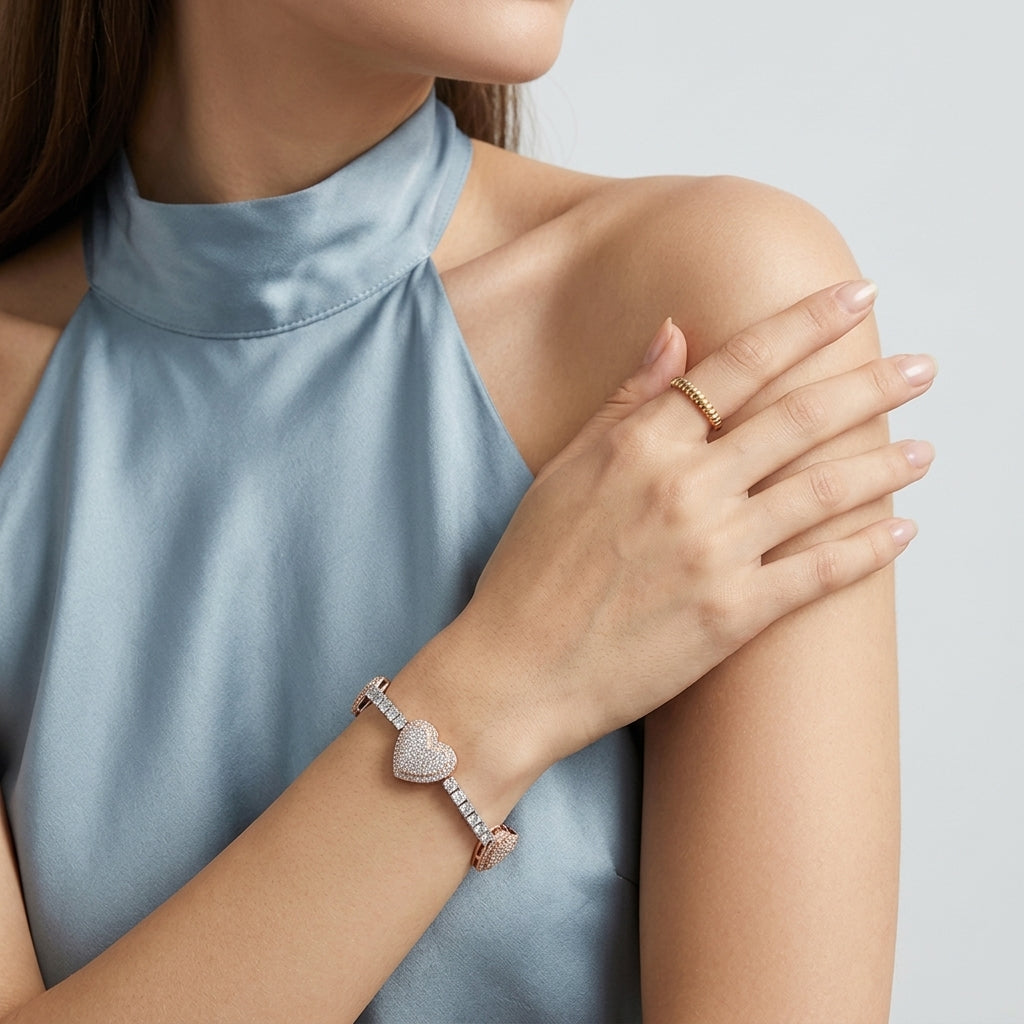 Model wearing pave heart moissanite tennis bracelet with rose gold accents on wrist