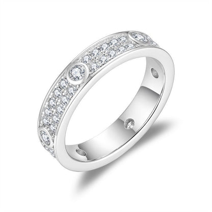 Angled product view of double row pavé moissanite full eternity band showcasing side bezel details.