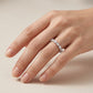 Close-up shot of model hand wearing pear cut 2.5x4mm lab grown diamond eternity ring.