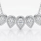 Close-up view of bezel set graduated pear cut moissanite teardrop bar pendant.