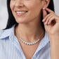Model wearing pear cut bezel set moissanite teardrop smile necklace.