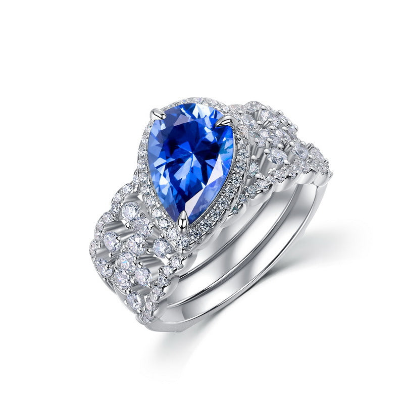 Luxury 2-piece pear-cut blue sapphire stackable ring set for women with a brilliant pave cluster.