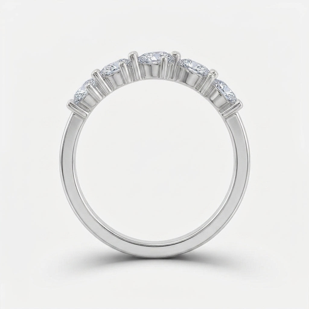 Side arch profile shot of pear cut lab diamond half eternity band ring.