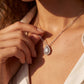 Model wearing pear cut lab grown diamond halo teardrop pendant necklace.