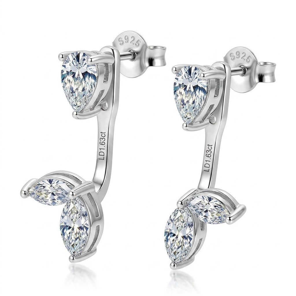 Angled pair of pear cut stud and marquise leaf cluster ear jacket earrings.