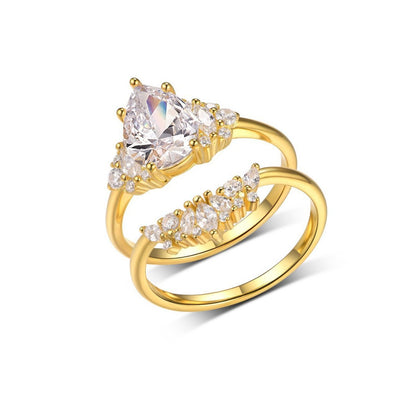 Pear cut moissanite cluster solitaire and curved crown stacking ring set in 18K gold plated silver.