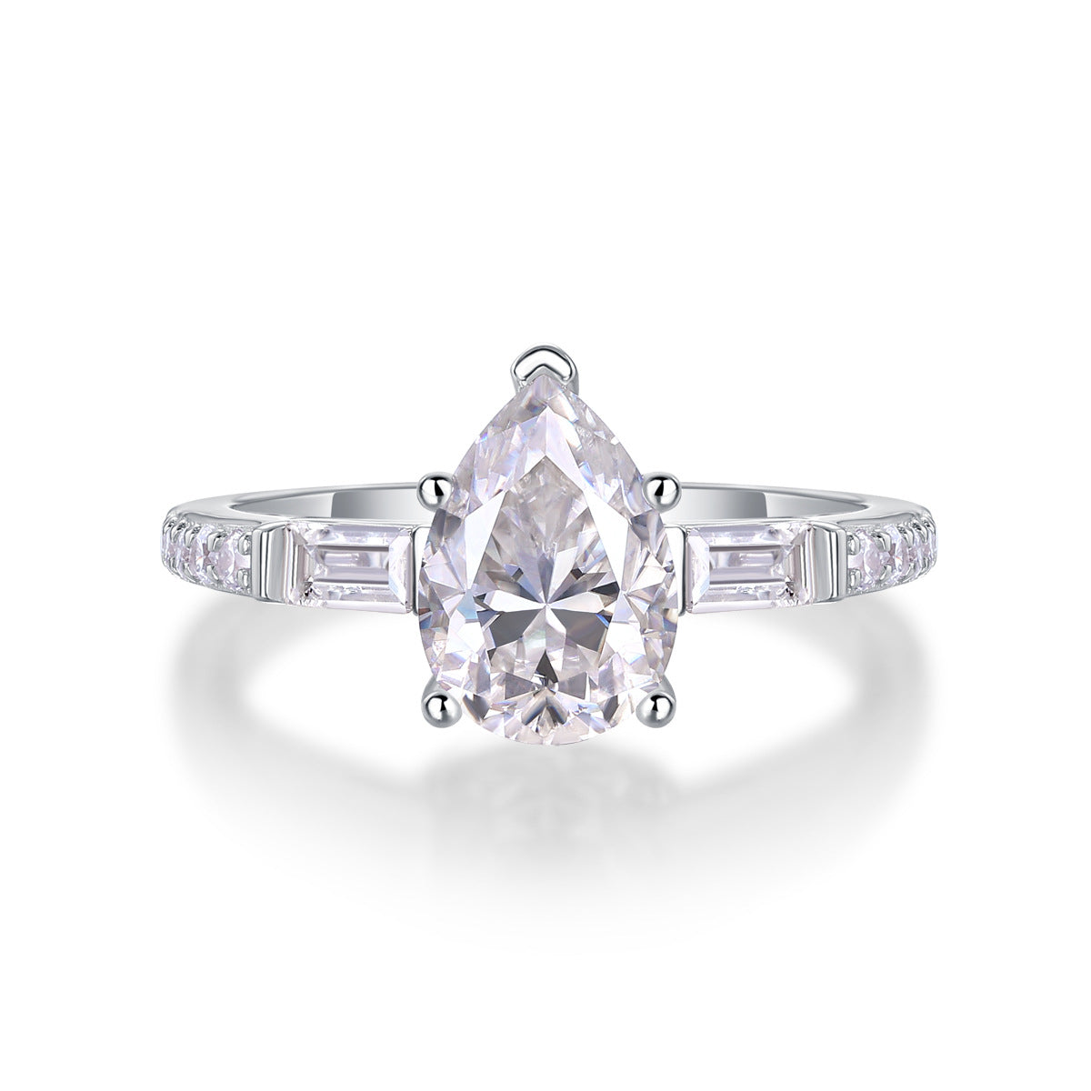 Pear cut moissanite engagement ring with baguette side accents and pave band on white background.