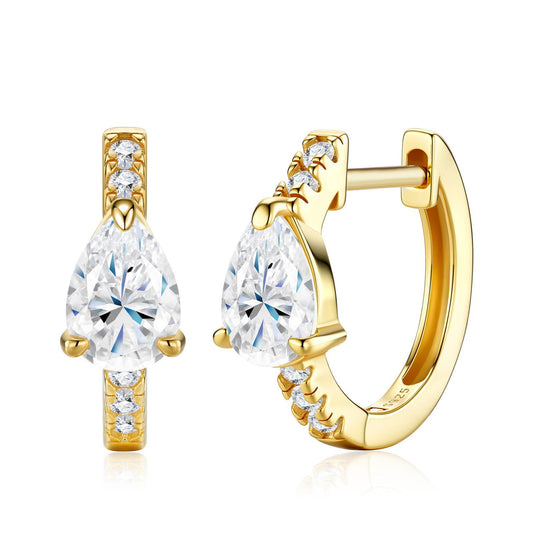 Gold pavé huggie hoop earrings featuring a solitaire pear cut moissanite center stone on white background.