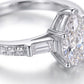 Macro close-up view of baguette side accent stones and pavé setting on pear moissanite ring.