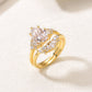 Perspective shot of gold pear cut moissanite cluster solitaire and curved crown stacking set.
