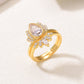 Perspective view of 18K gold plated pear cut moissanite lotus halo and crown ring set.