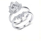 Profile view of model wearing pear cut moissanite lotus halo and crown ring set.