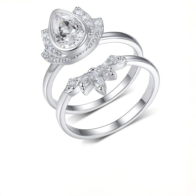 Profile view of model wearing pear cut moissanite lotus halo and crown ring set.