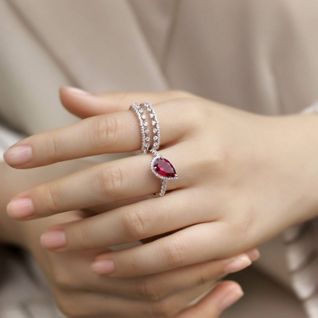 Elegant model showing the pear-cut ruby stackable ring set styled flawlessly on her finger.
