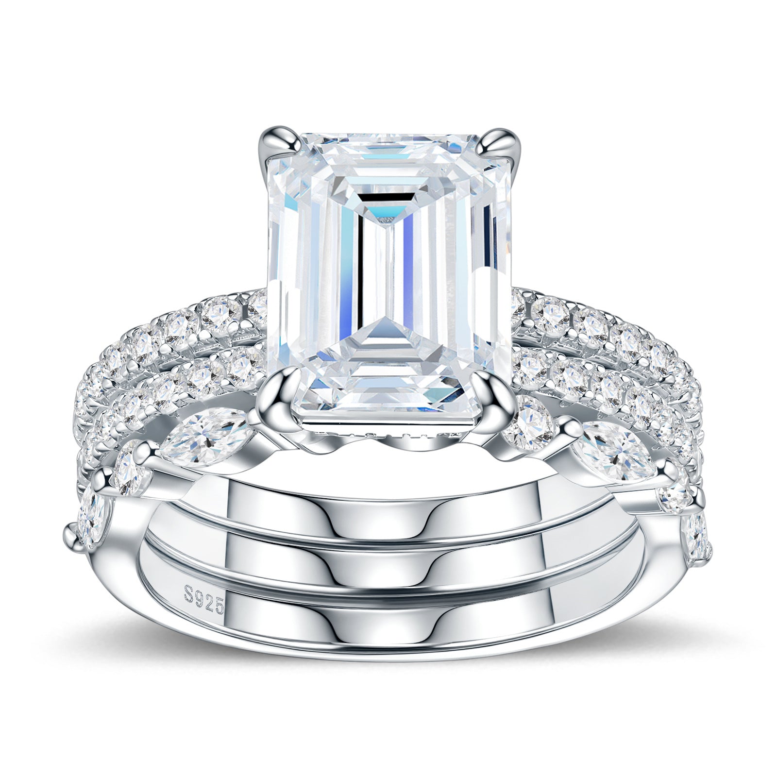 Symmetrical studio display of platinum plated emerald cut moissanite 3 piece stacking ring set with marquise and pave bands.