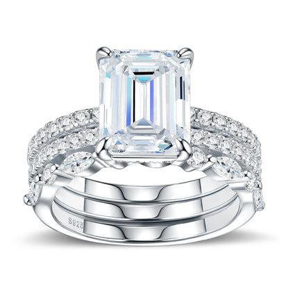 Symmetrical studio display of platinum plated emerald cut moissanite 3 piece stacking ring set with marquise and pave bands.