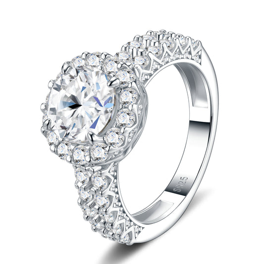Symmetrical studio view of platinum plated round cut moissanite halo engagement ring with double row pave band.