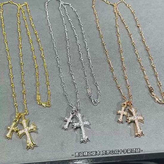 “Gold and silver double cross necklace flat lay showing zircon pendant and link chain”