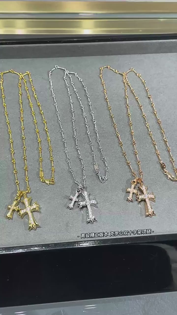 “Gold and silver double cross necklace flat lay showing zircon pendant and link chain”