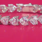 Bracelet stacked with other pieces. Alt: “Stackable Love: Heart Moissanite Bracelet.”