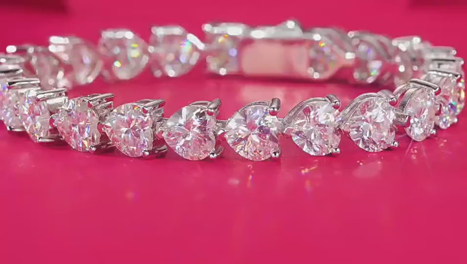 Bracelet stacked with other pieces. Alt: “Stackable Love: Heart Moissanite Bracelet.”