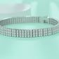 Yellow gold three-row moissanite bracelet on neutral background. Alt: “Three-Row Moissanite Tennis Bracelet – 18K Yellow Gold.”