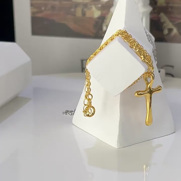 “Flat lay of S925 sterling silver molten cross pendant necklace with irregular texture”