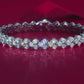 Yellow gold heart moissanite bracelet on neutral background. Alt: “Heart Moissanite Tennis Bracelet – 18K Yellow Gold.”