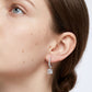 Model wearing 2.4ctw princess cut diamond dangle huggie hoop earrings.