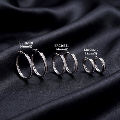 Princess cut moissanite channel set huggie hoop earrings in various hoop sizes on dark silk background   