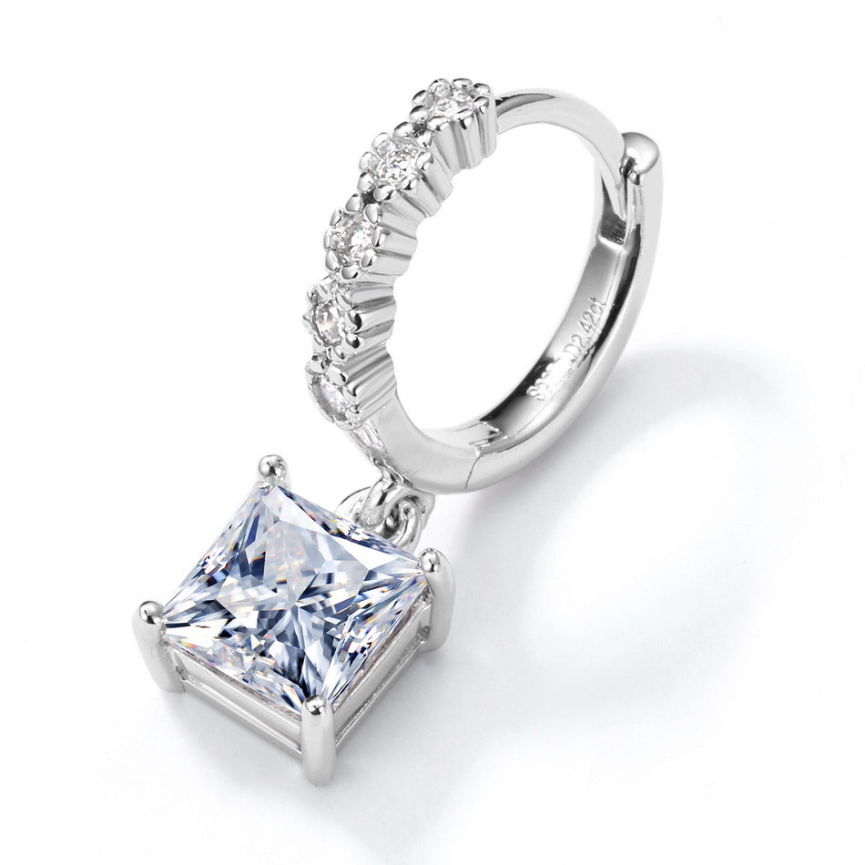 Angled single perspective of princess cut solitaire dangle huggie hoop earring with pavé channel.