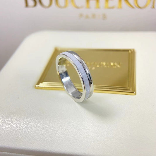 Close-up shot of a contemporary Quatre inspired double white HyCeram ceramic ring in a 925 silver finish on a luxury box.