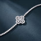 5.52 CTW diamond quatrefoil flower tennis bracelet displayed on dark blue background.