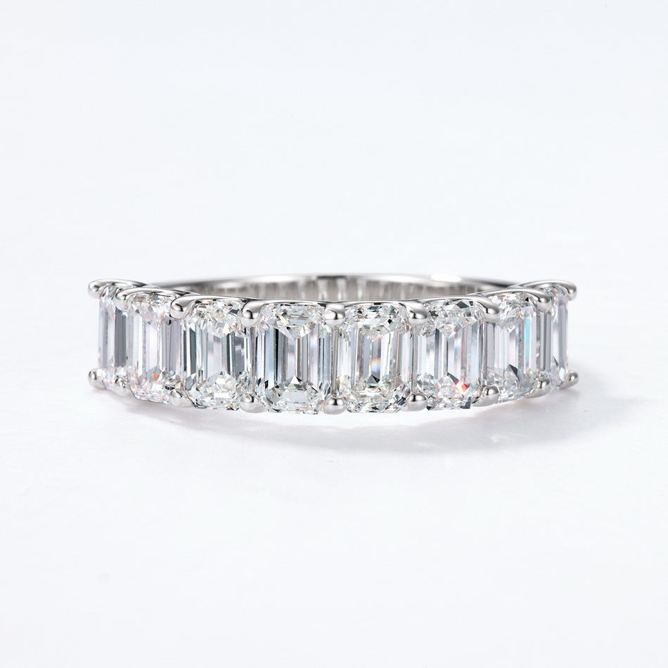 Front view of emerald cut diamond simulant half-eternity anniversary band.