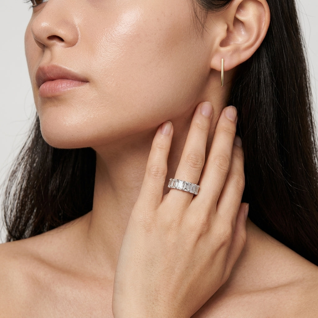 Model wearing radiant emerald cut diamond simulant anniversary band ring.