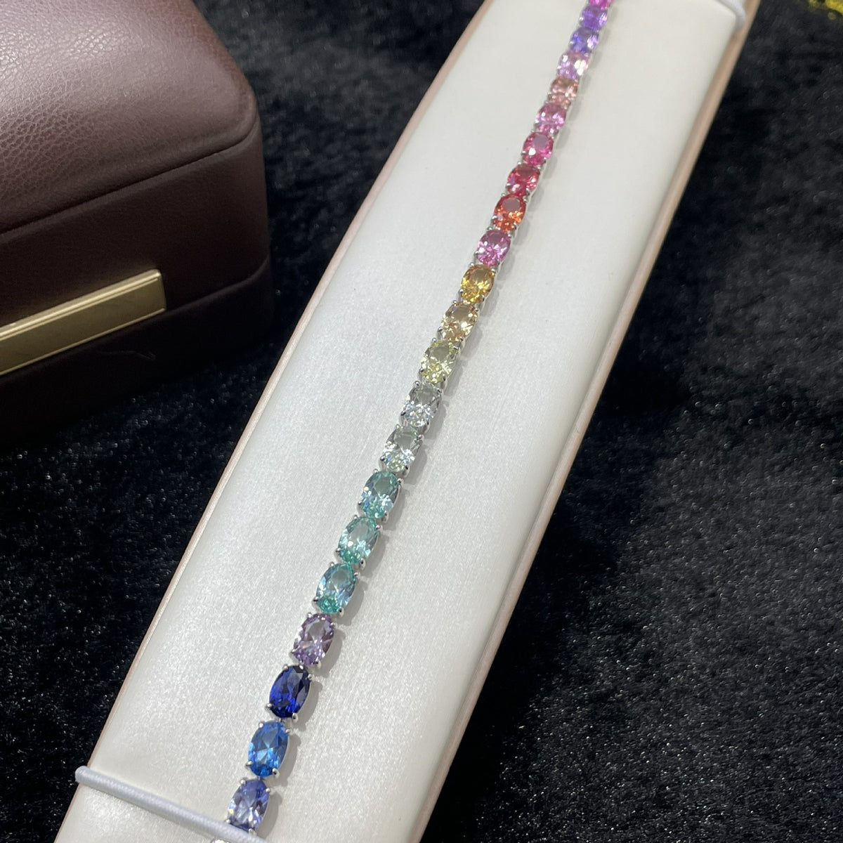 Full spectrum rainbow gradient view of oval cut gemstone tennis bracelet.
