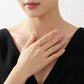 Fashion model in a black dress wearing the elegant gold bow knot stacking ring.