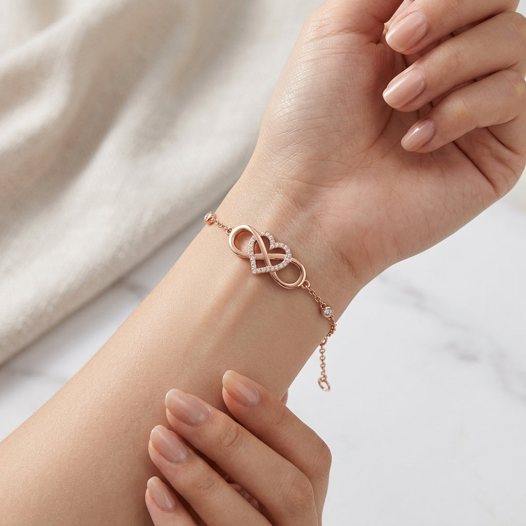 Model wearing rose gold infinity heart pavé moissanite station chain bracelet.