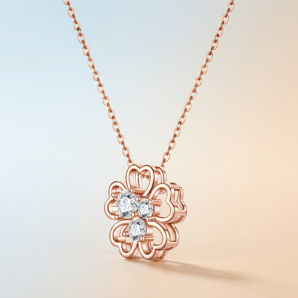 Close-up shot of rose gold openwork clover pendant with sparkling moissanite stones.