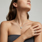 Model wearing round bezel set lab grown diamond solitaire pendant necklace on collarbone.
