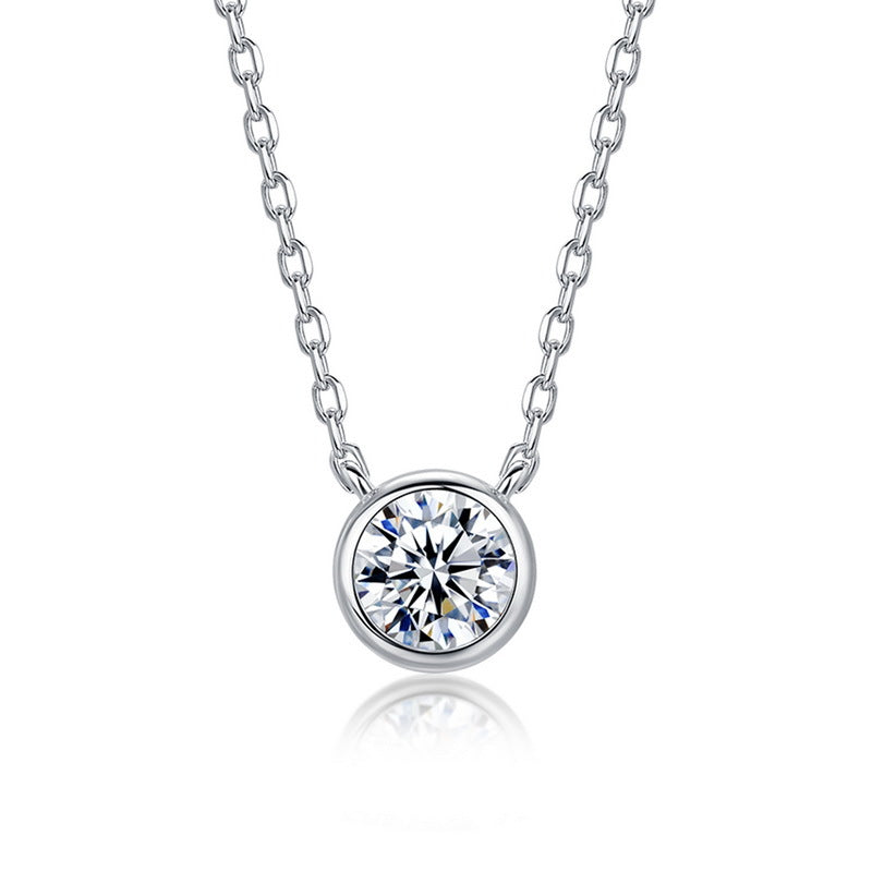 Round bezel set lab grown diamond solitaire pendant necklace in 925 sterling silver.