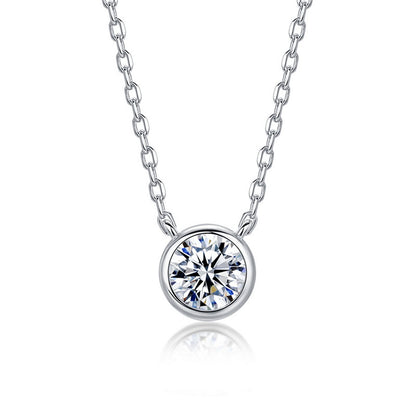 Round bezel set lab grown diamond solitaire pendant necklace in 925 sterling silver.