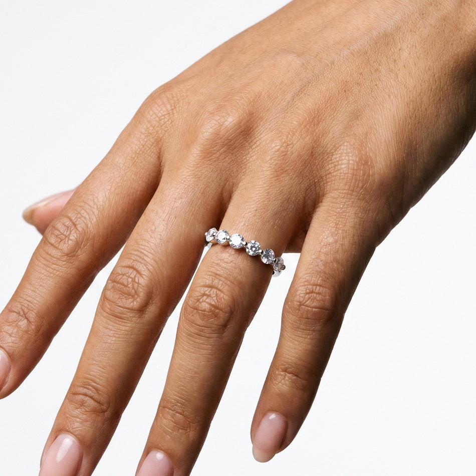 Alternative hand angle view of round brilliant 7-stone anniversary wedding band ring.