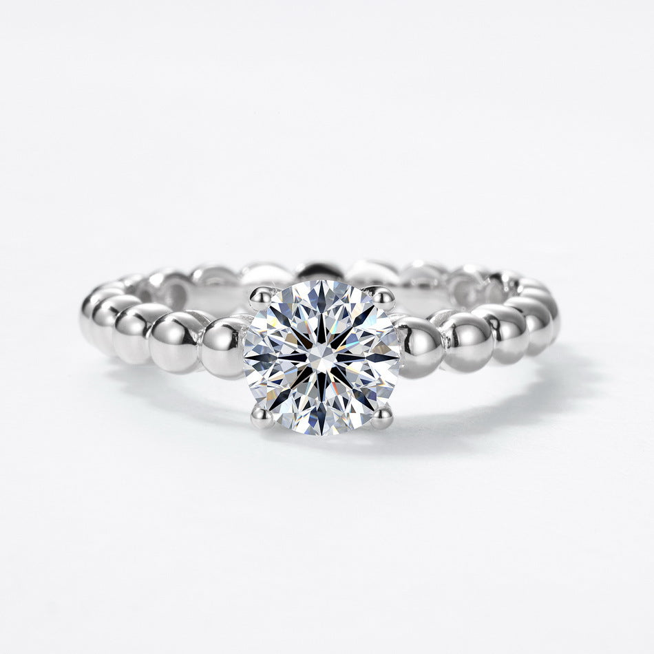 Front perspective view of round brilliant cut bubble band solitaire ring.