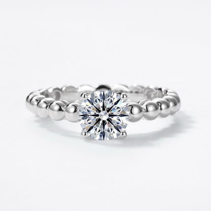 Front perspective view of round brilliant cut bubble band solitaire ring.
