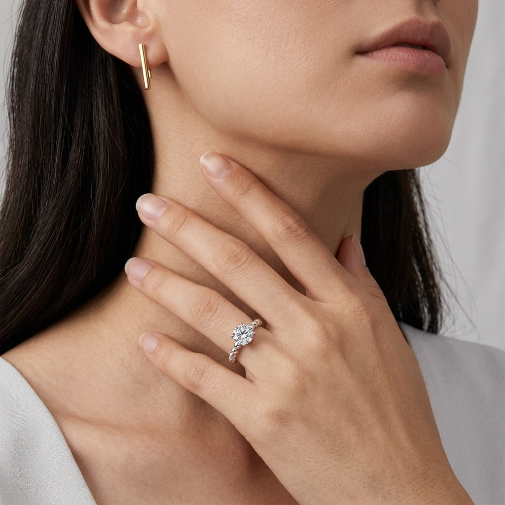 Model wearing round brilliant bubble band solitaire engagement ring.